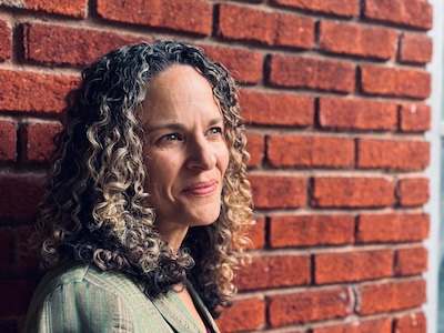 Katherine Skinner headshot against red brick wall