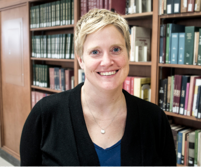 heather weltin standing in front of bookshelves